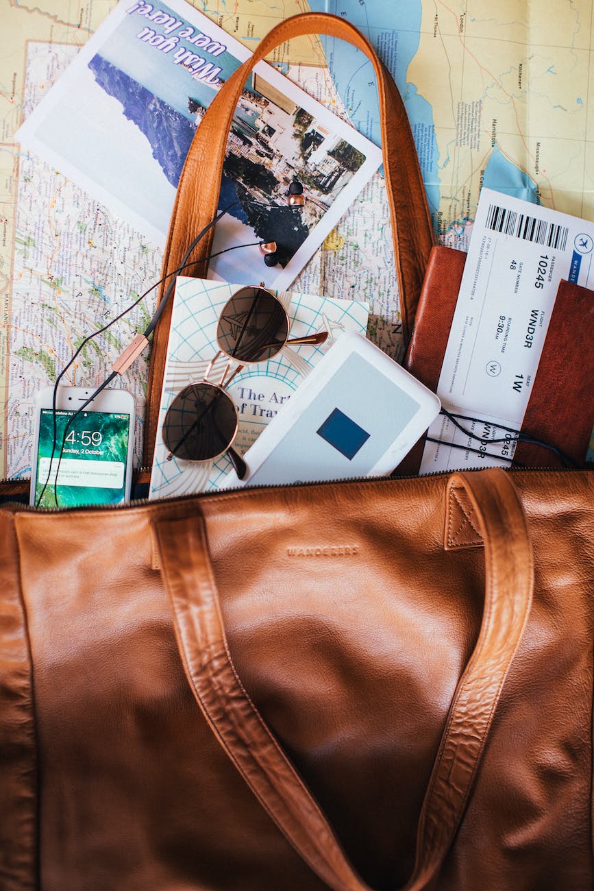 an open bag with maps and tickets